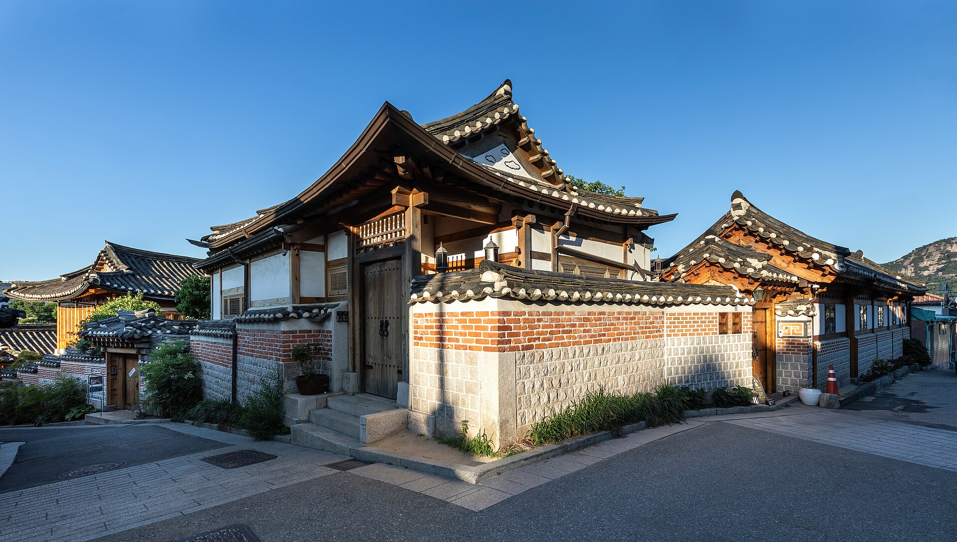 Traditional Korean Hanok roofs in Bukchon Hanok Village under golden sunlight